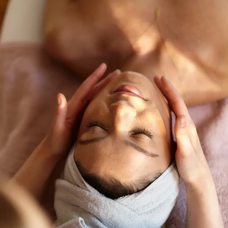 Woman receiving a relaxing facial massage