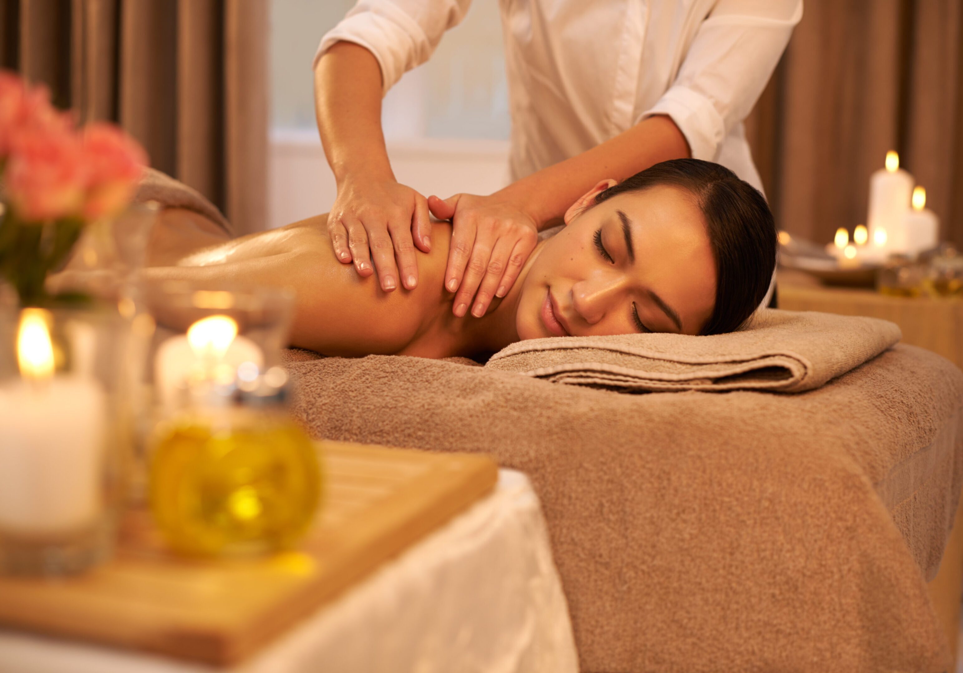 A beautiful young woman enjoying a massage at the spa